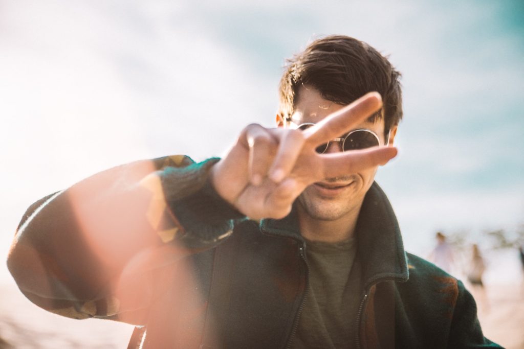 man wearing sunglasses and doing peace sign