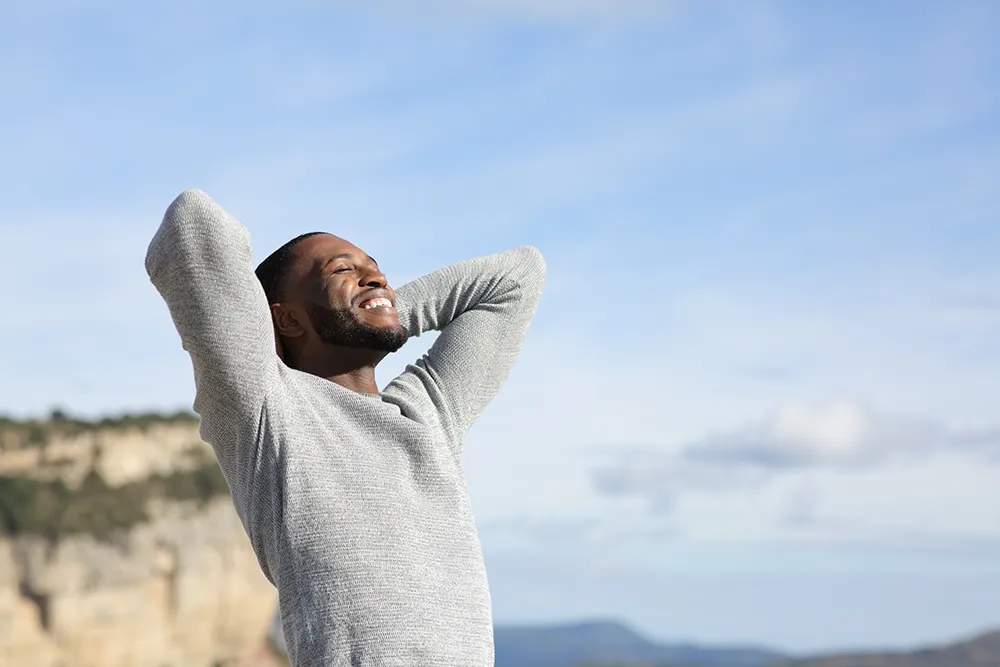 medications-we-offer man stretching at a hill top